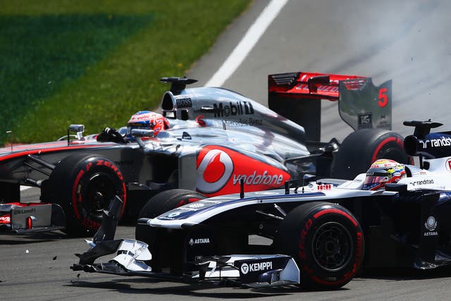 Jenson Button of Great Britain and McLaren and Pastor Maldonado of Venezuela and Williams drive side by side into the hairpin during the Canadian Formula One Grand Prix