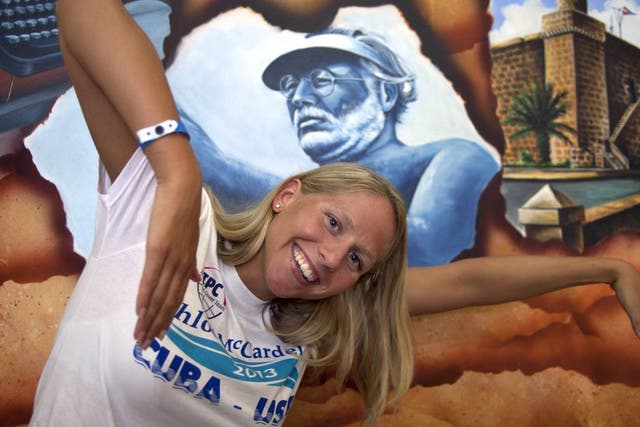 Australian swimmer Chloe McCardel, 29, poses in a swimming position in front of a painting of Ernest Hemingway inside a hotel at the Marina Hemingway after an interview in Havana, Cuba