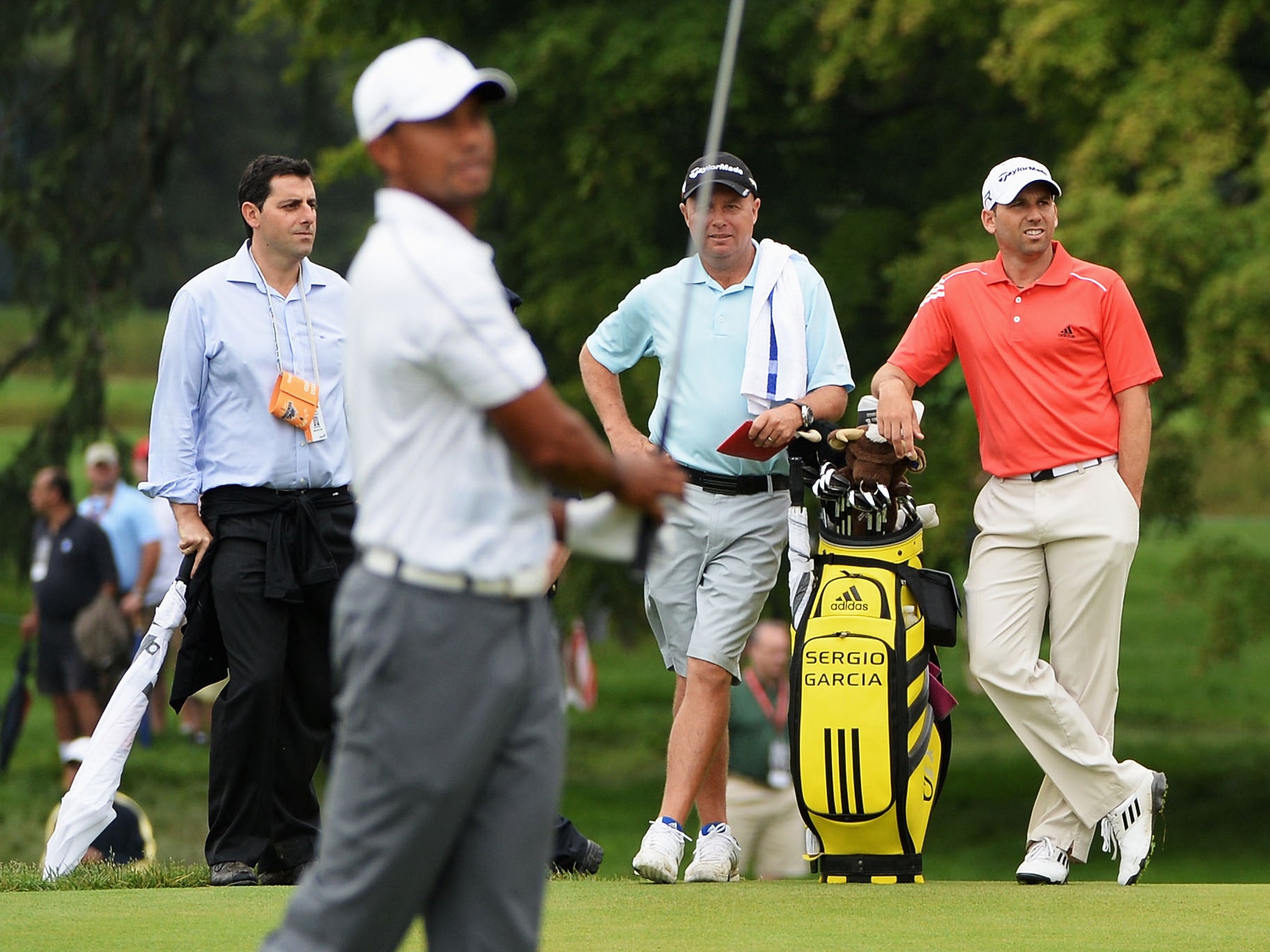Sergio Garcia watches Tiger Woods at the driving range