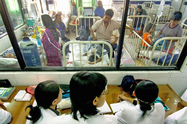 Doctors observe patients suffering from dengue fever during an outbreak of the virus in Jakarta, Indonesia, in 2005. The disease is common in Asia