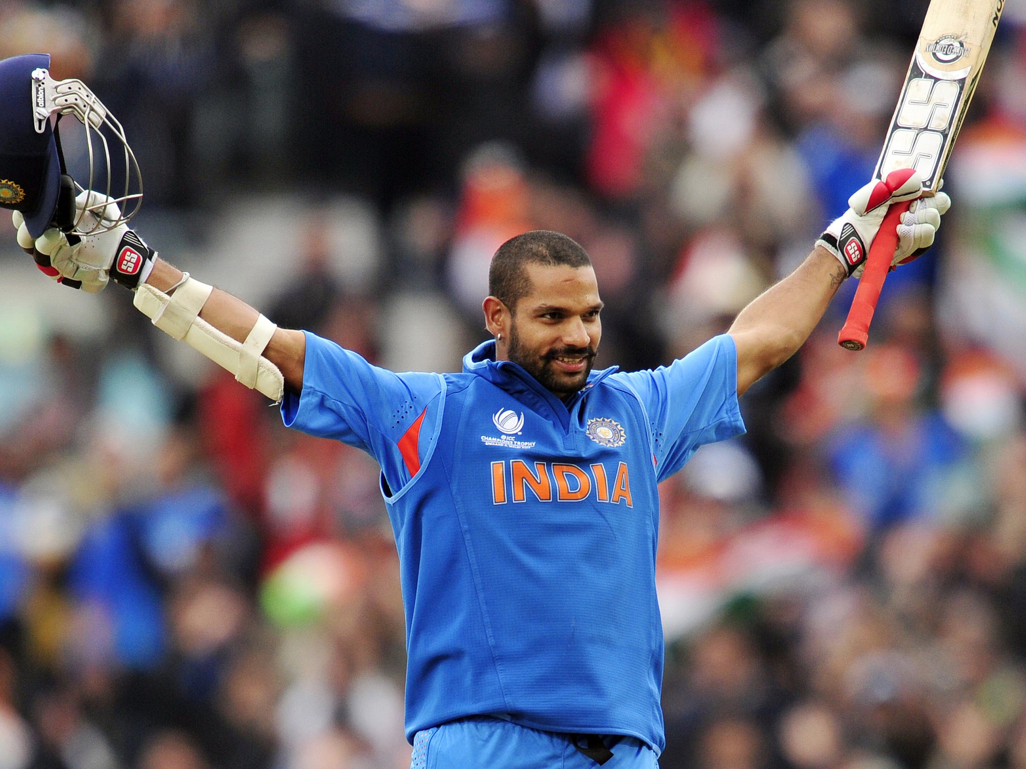 India's Shikhar Dhawan celebrates his century (100 Runs) during the 2013 ICC Champions Trophy One Day International (ODI) cricket match between India and West Indies at The Oval in London