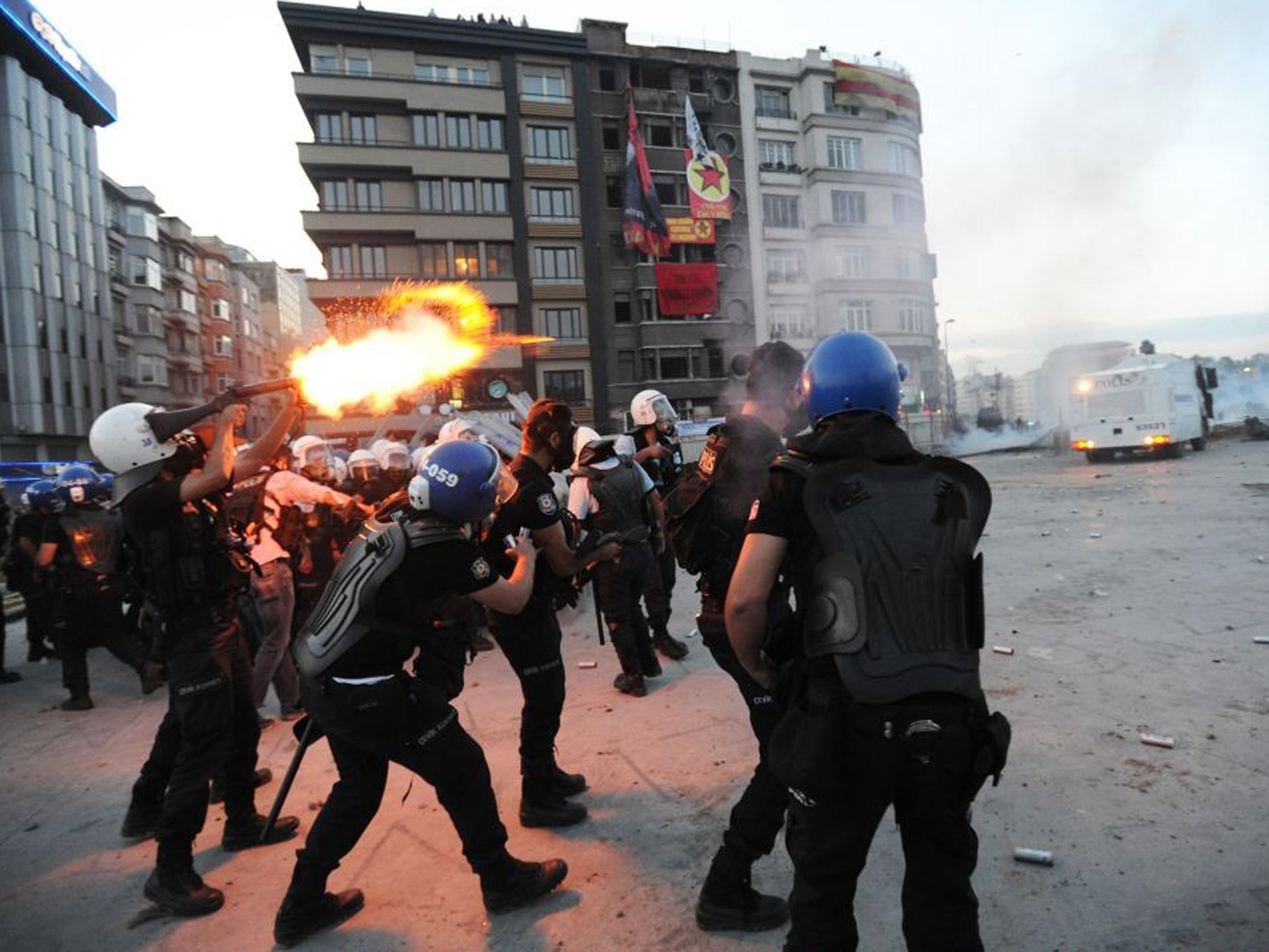 Turkish police fire tear gas at anti-government protesters as they try to reestablish police control of Taksim Square