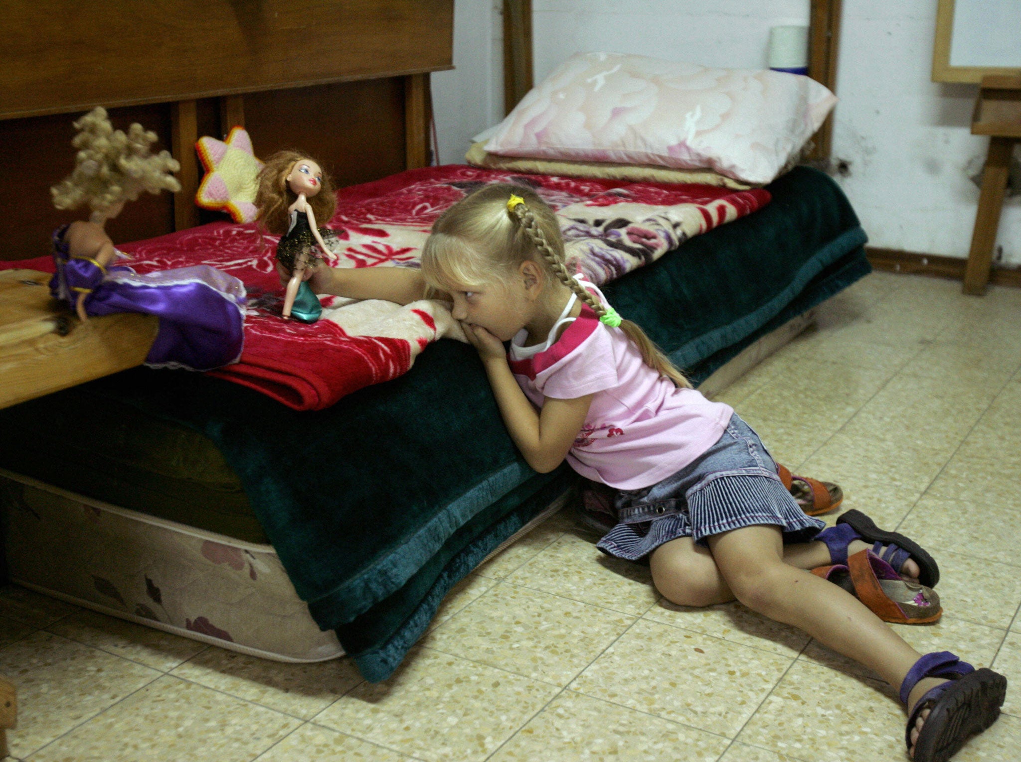 A little girl plays with her dolls