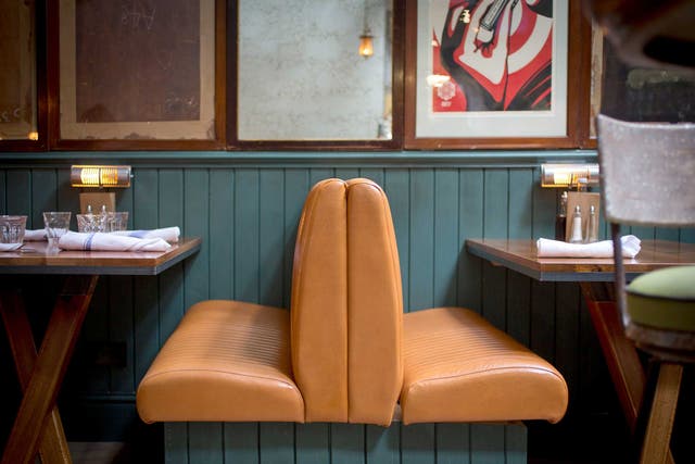 Artfully designed: The Fish & Chip Shop features grey tables, blue wood panels and 1940s furniture