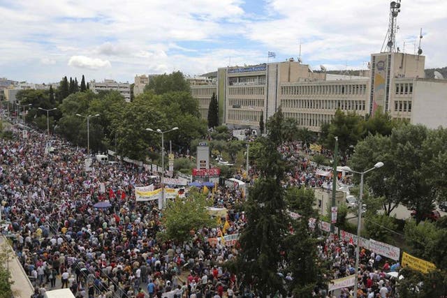 Greeks protest outside of the occupied ERT TV and Radio headquarters in Athens following a shock decision by the government to shut down the state broadcaster