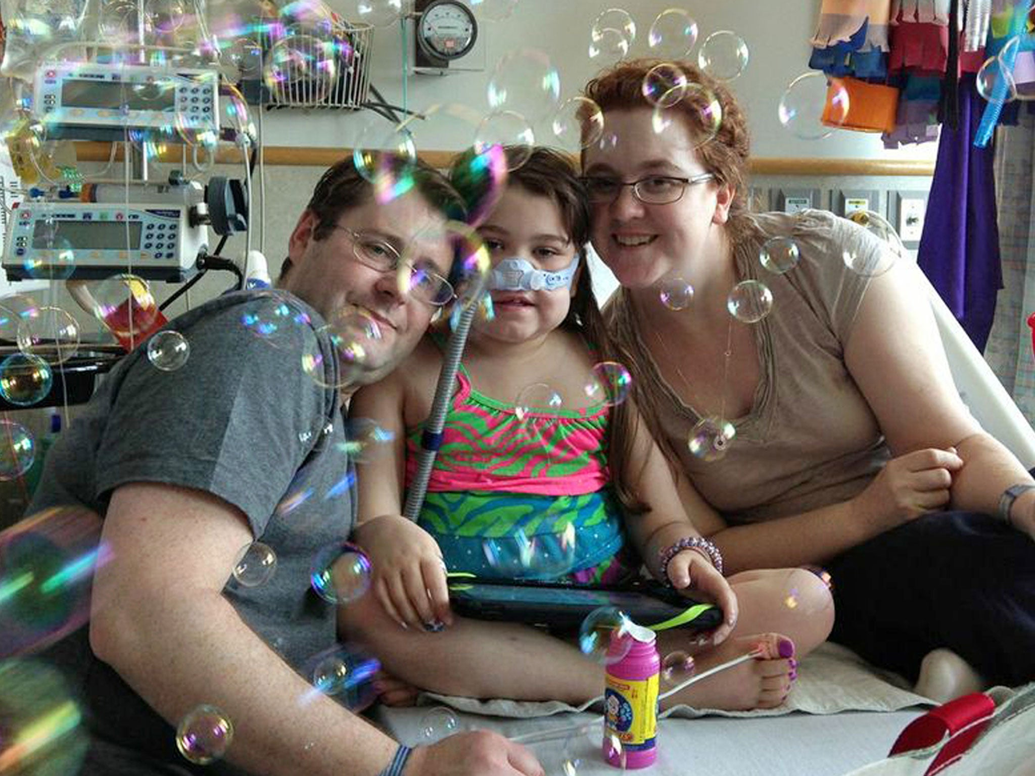Sarah Murnaghan, centre, with her parents; she is said to be making good progress following the operation