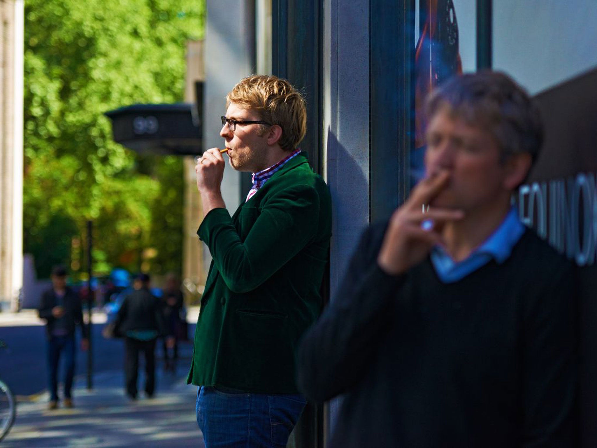 Samuel Masters smoking an e-cigarette outside an office building