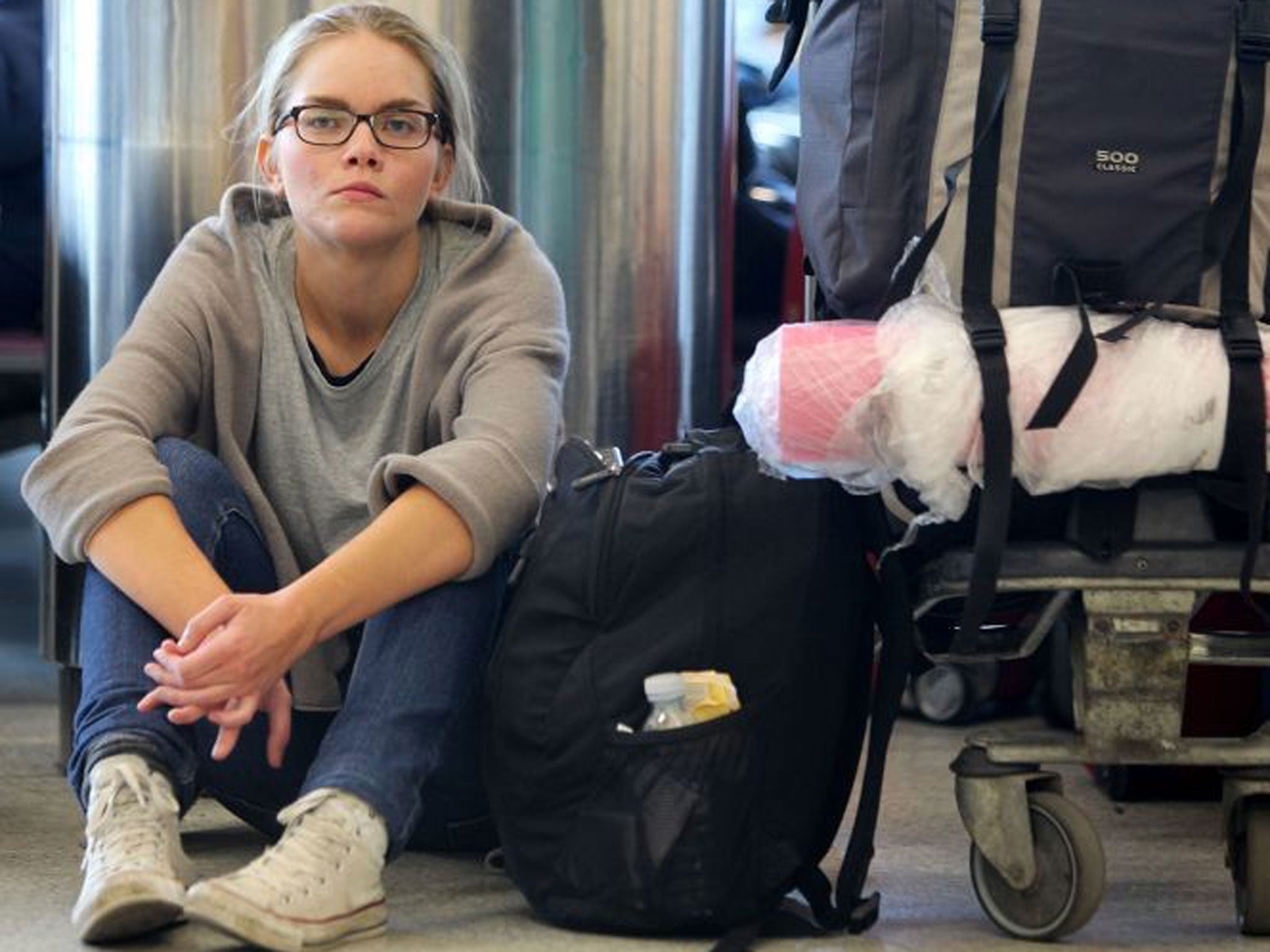 An airline passenger waits for a flight at Edinburgh airport