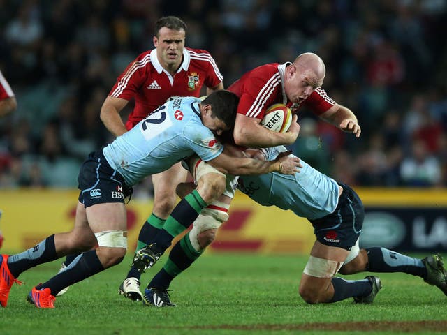 Hard lesson:Paul O'Connell is tackled by Tom Carter