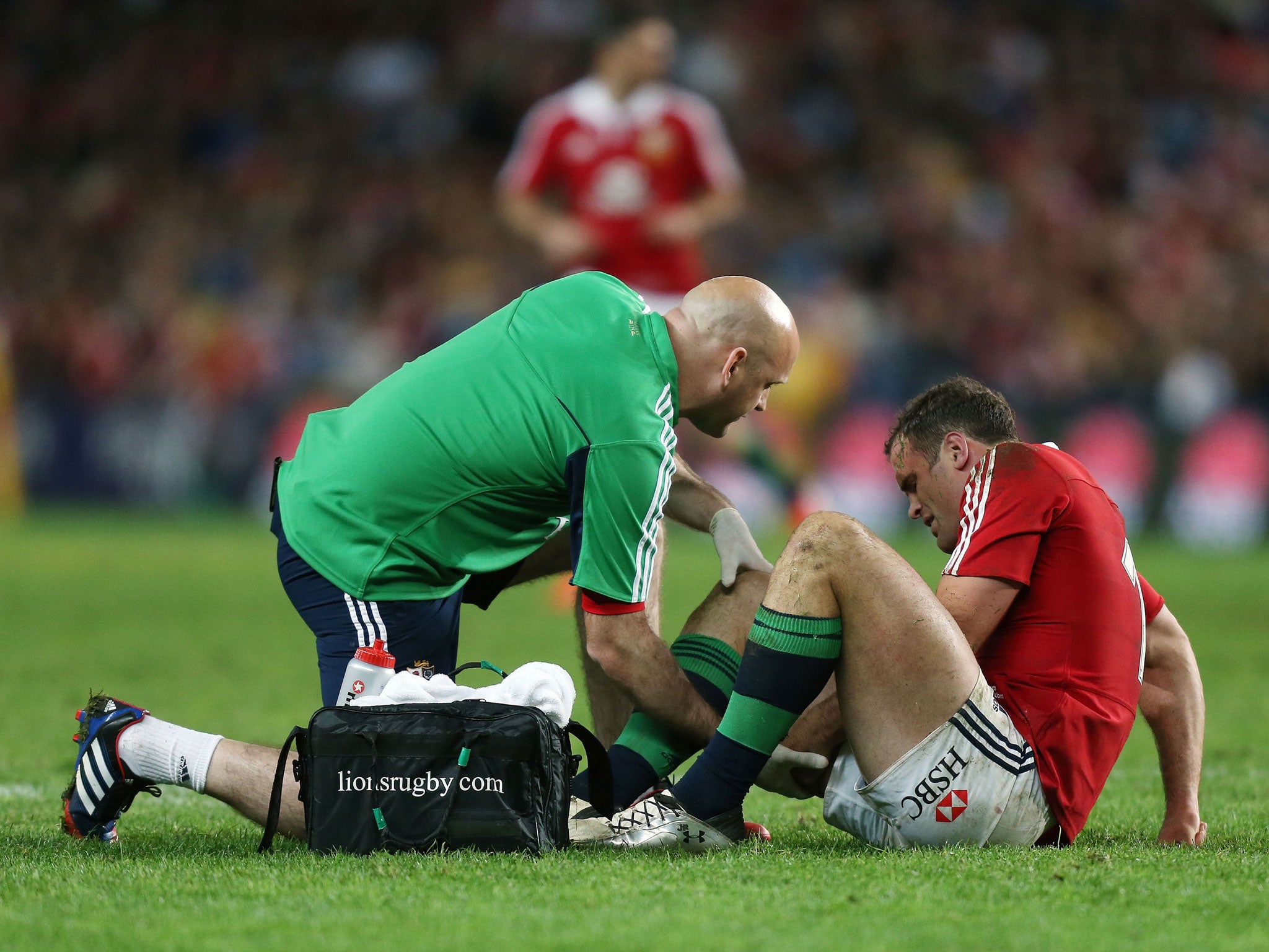 Lion down: Jamie Roberts, the squad's only specialist inside-centre, receives treatment for a worrying injury sustained in the win over the Waratahs