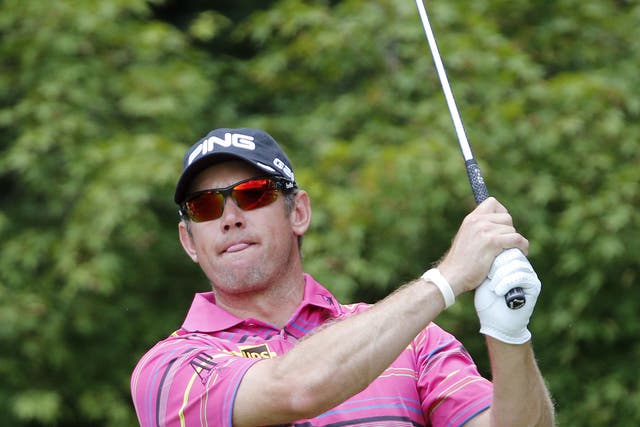 Eye full: Lee Westwood watches his tee shot at the second
