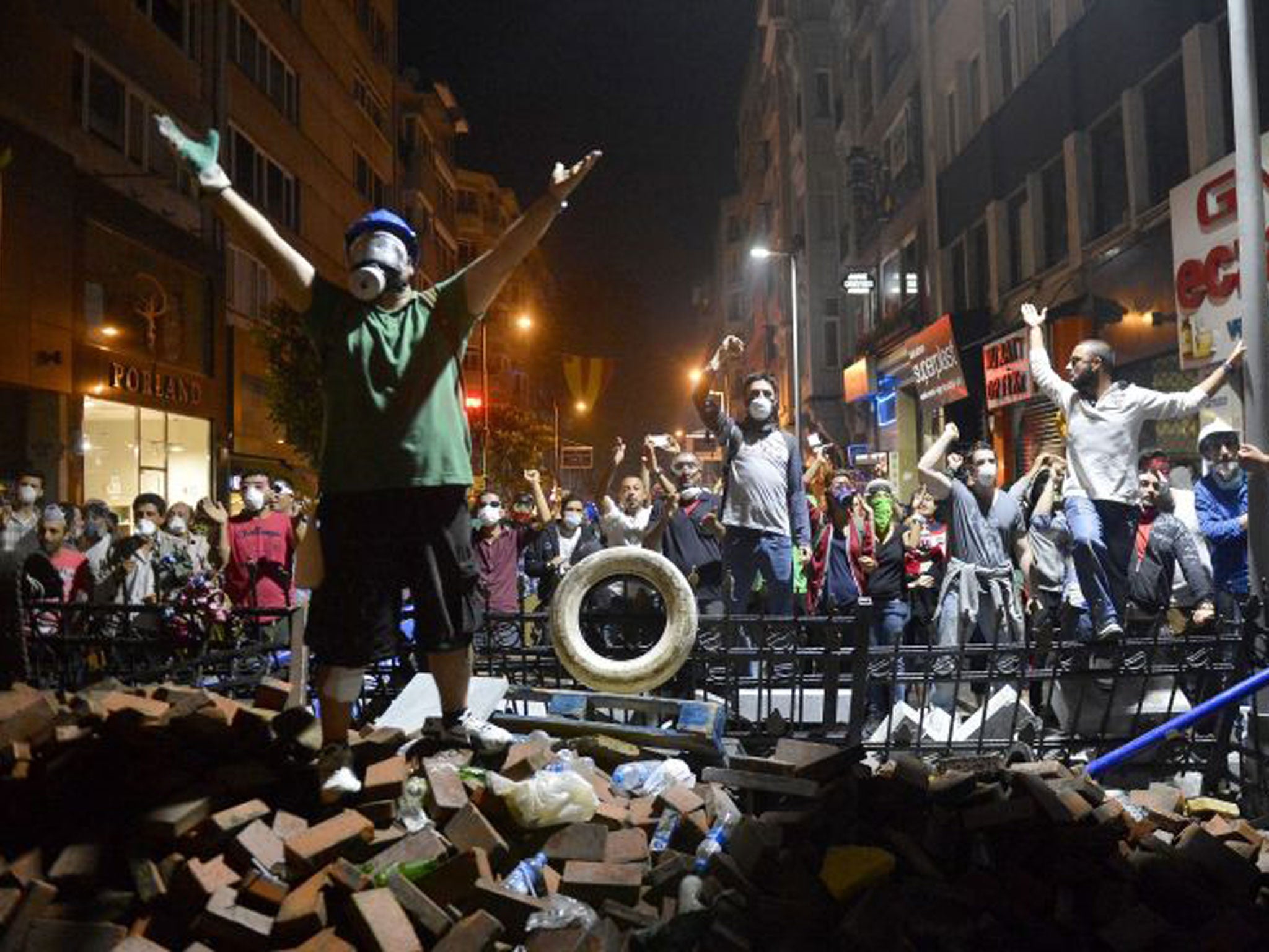Protesters shouting anti-government slogans from a barricade during clashes with police in Istanbul