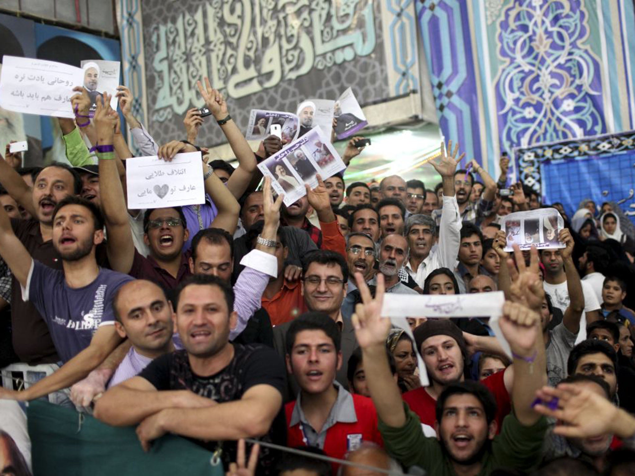 Supporters of the Iranian President elect Hasan Rouhani, react, as he visits the shrine of the late revolutionary founder Ayatollah Khomeini on Sunday