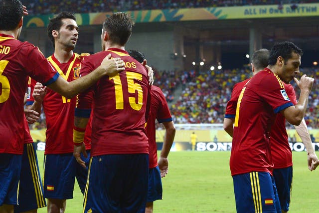 Spain's forward Pedro Rodriguez (R) celebrates after scoring against Uruguay