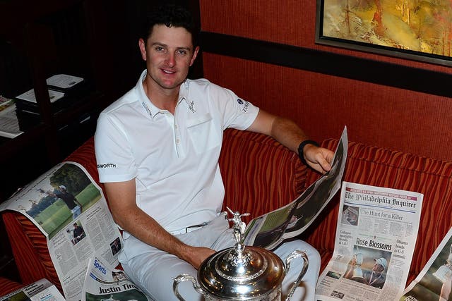 Justin Rose has a look at the papers the morning after his US Open triumph