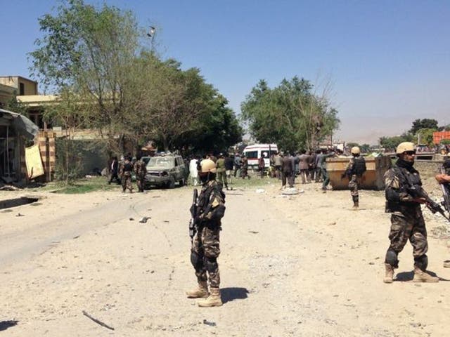 Afghanistan security forces stand guard at the site of a blast