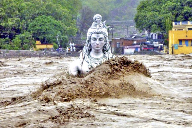 A submerged idol of Hindu Lord Shiva stands in the flooded River Ganges in Rishikesh, in the northern Indian state of Uttarakhand