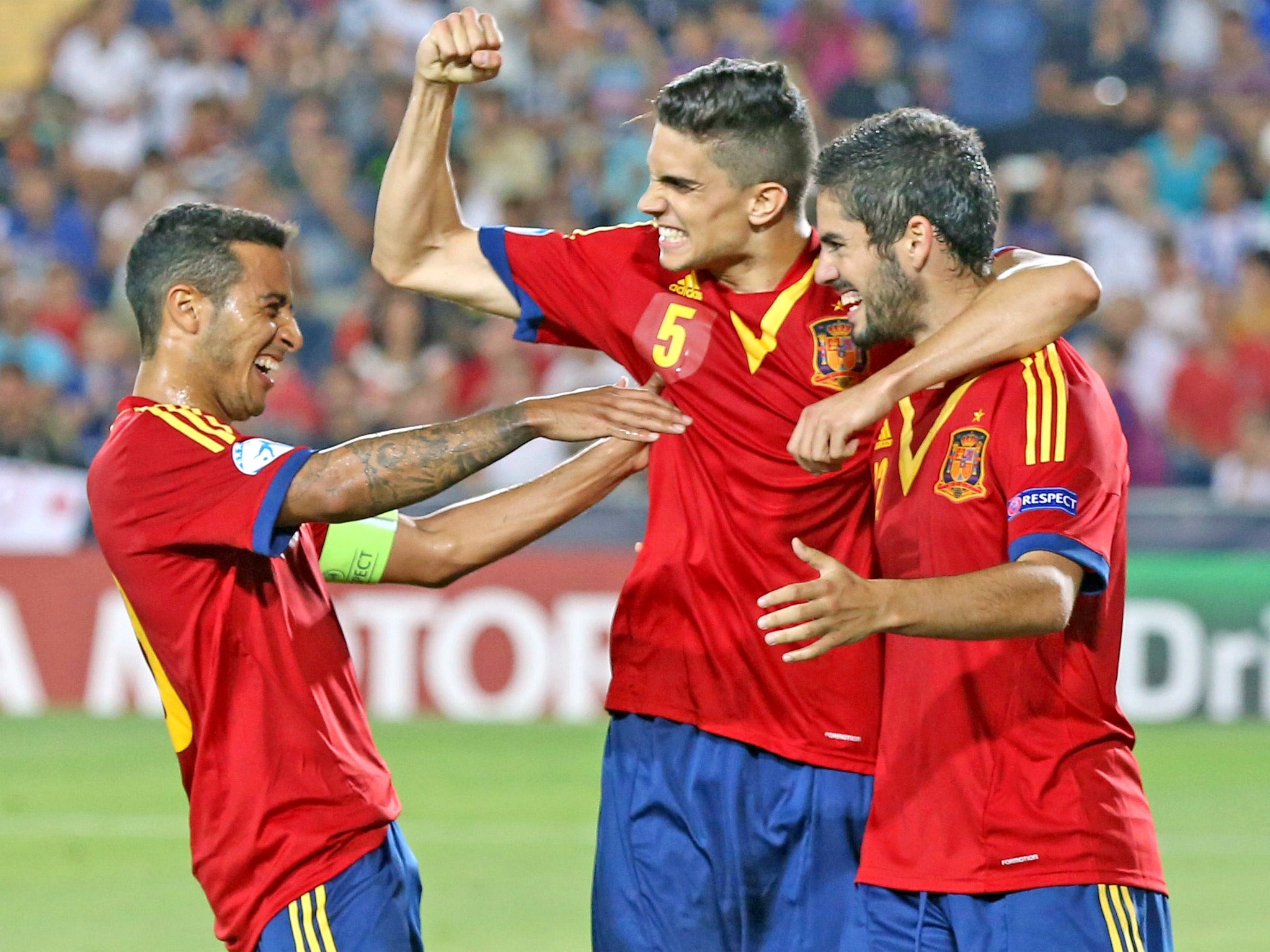 Isco (right) celebrates Spain's fourth goal with teammates Marc Bartra (centre) and Thiago, who scored the first three