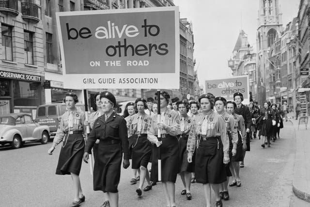 A troop of Girl Guides march down Fleet Street in London, as part of the new Road Safety Campaign organised by the Royal Society for the Prevention of Accidents, 22nd April 1961.