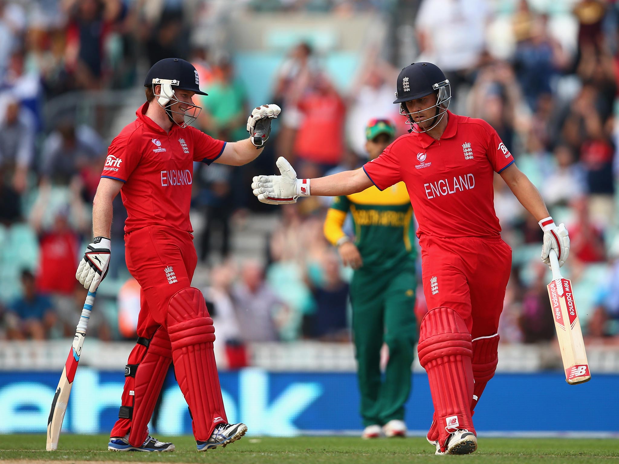 Jonathan Trott and Eoin Morgan of England celebrate hitting the winning runs as England secure a place in the final