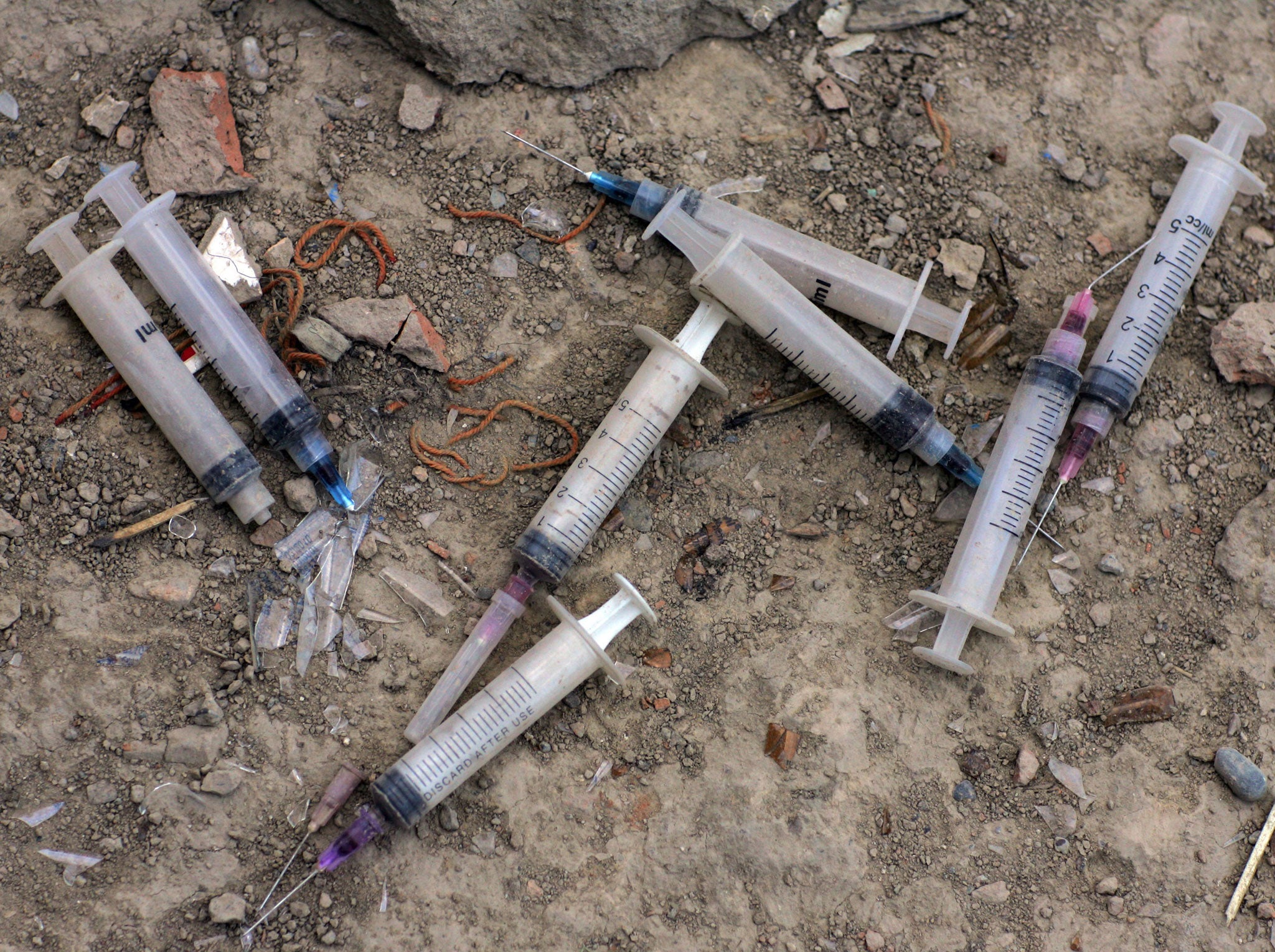 Used needles litter the ground outside an abandoned building where many addicts live August 20, 2007 in Kabul, Afghanistan.