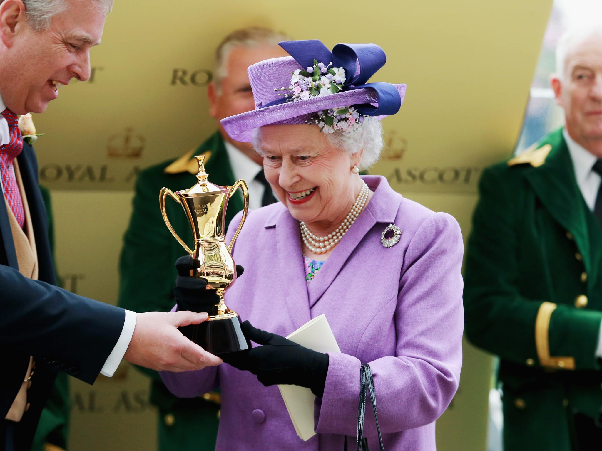 Queen Elizabeth II holds the Gold Cup alongside Prince Andrew, Duke of York after Ryan Moore rode Estimate to The Gold Cup during Ladies' Day on day three of Royal Ascot
