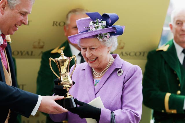 Queen Elizabeth II holds the Gold Cup alongside Prince Andrew, Duke of York after Ryan Moore rode Estimate to The Gold Cup during Ladies' Day on day three of Royal Ascot