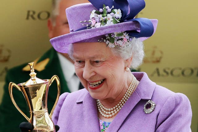The Queen is handed the Gold Cup at Ascot yesterday after victory for her horse, Estimate