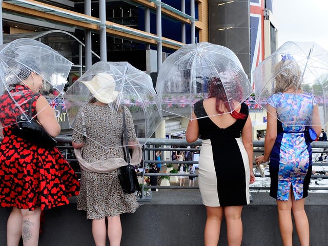 Racegoers shelter from rain at day four of Royal Ascot