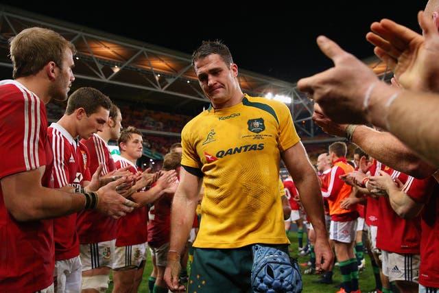 James Horwill is clapped off the field by the victorious Lions players