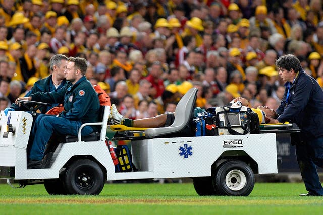 Christian Leali'ifano is taken from the field are suffering a head injury after just 52 seconds of his Test debut