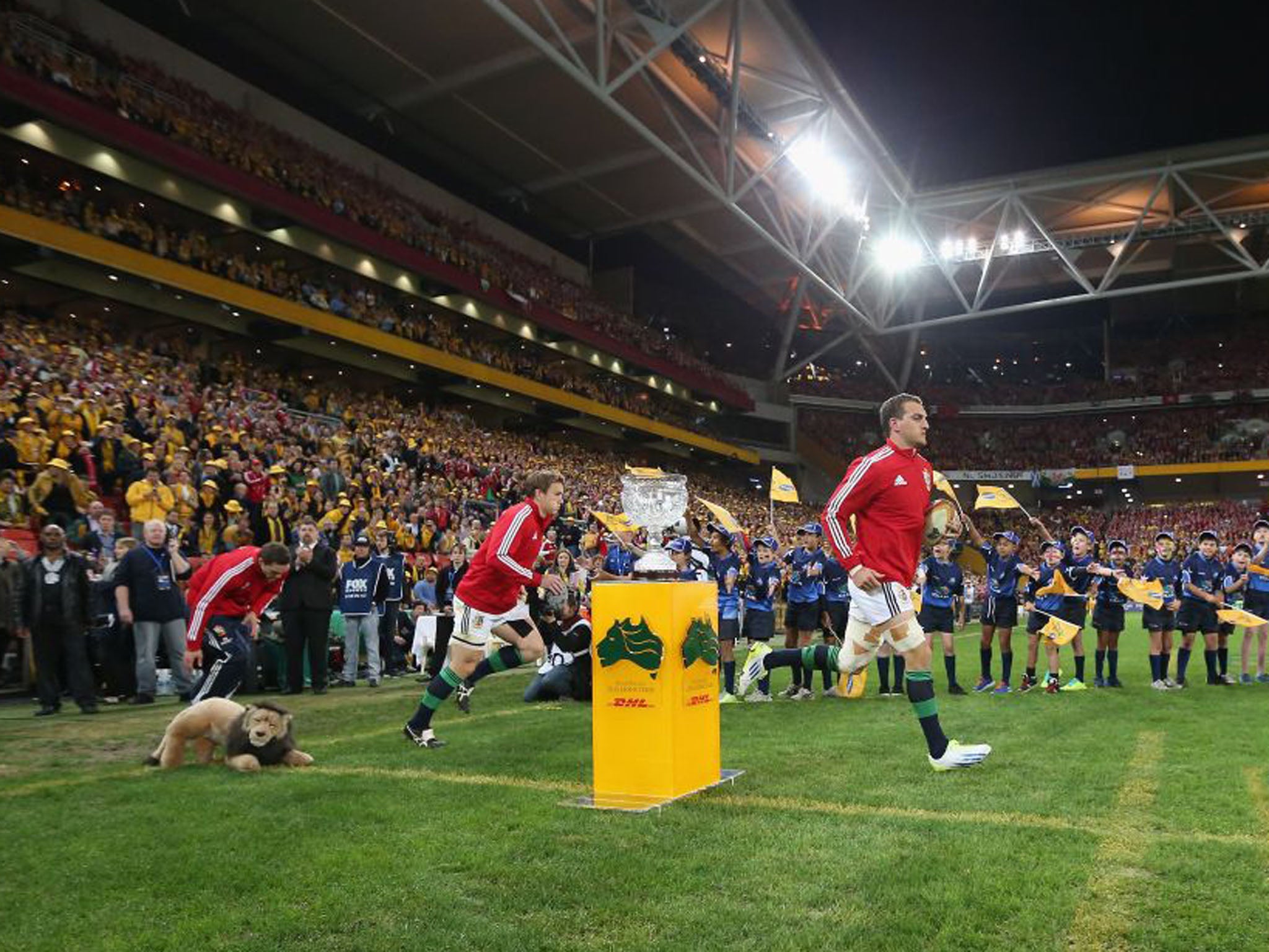 Sam Warburton, the Lions captain leads out his team before the match, in front of the Tom Richards Trophy, presented to the winning team. It is named after the only man to play for both the Lions and the Wallabies