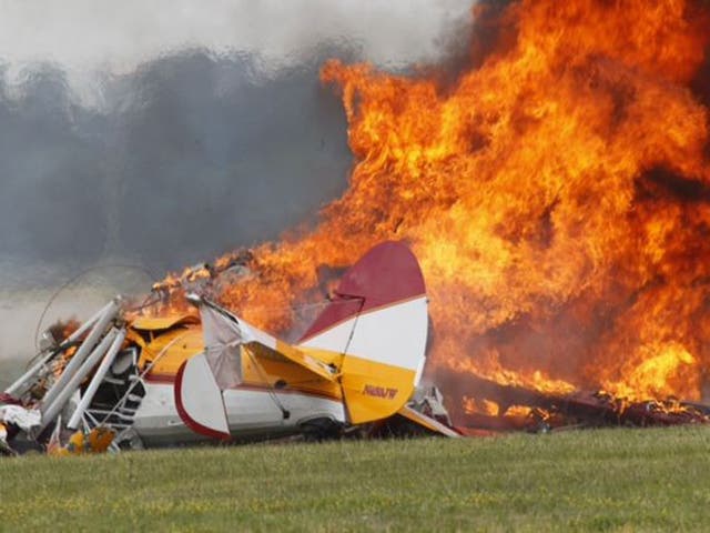 Flames erupt from a plane after it crashed at the Vectren Air Show at the airport in Dayton, Ohio