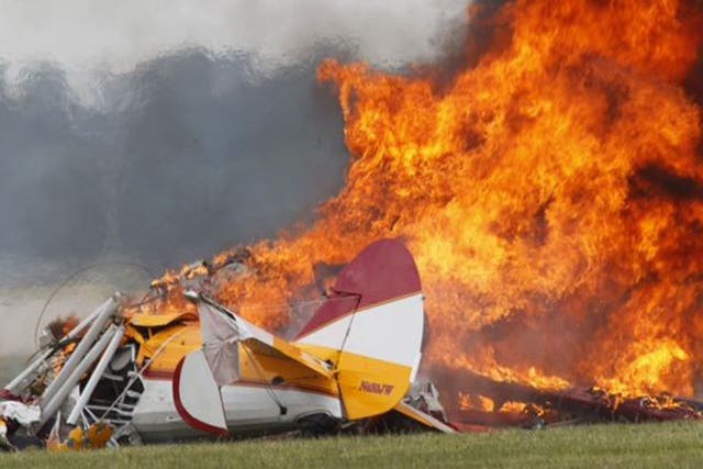 Flames erupt from a plane after it crashed at the Vectren Air Show at the airport in Dayton, Ohio
