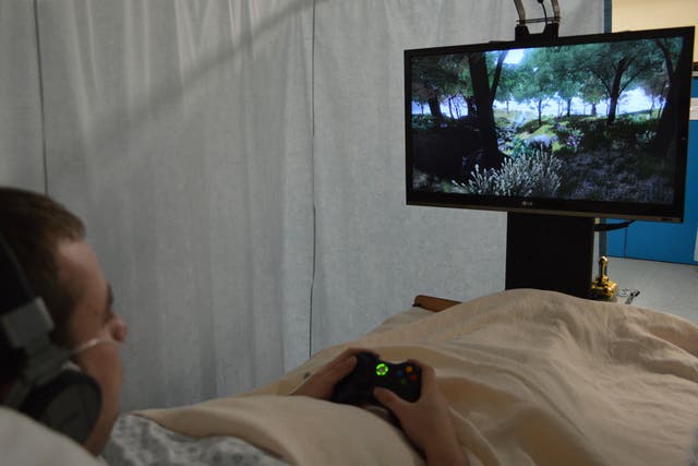 A patient watches a relaxing virtual-reality scene while receiving pioneering pain-relief treatment