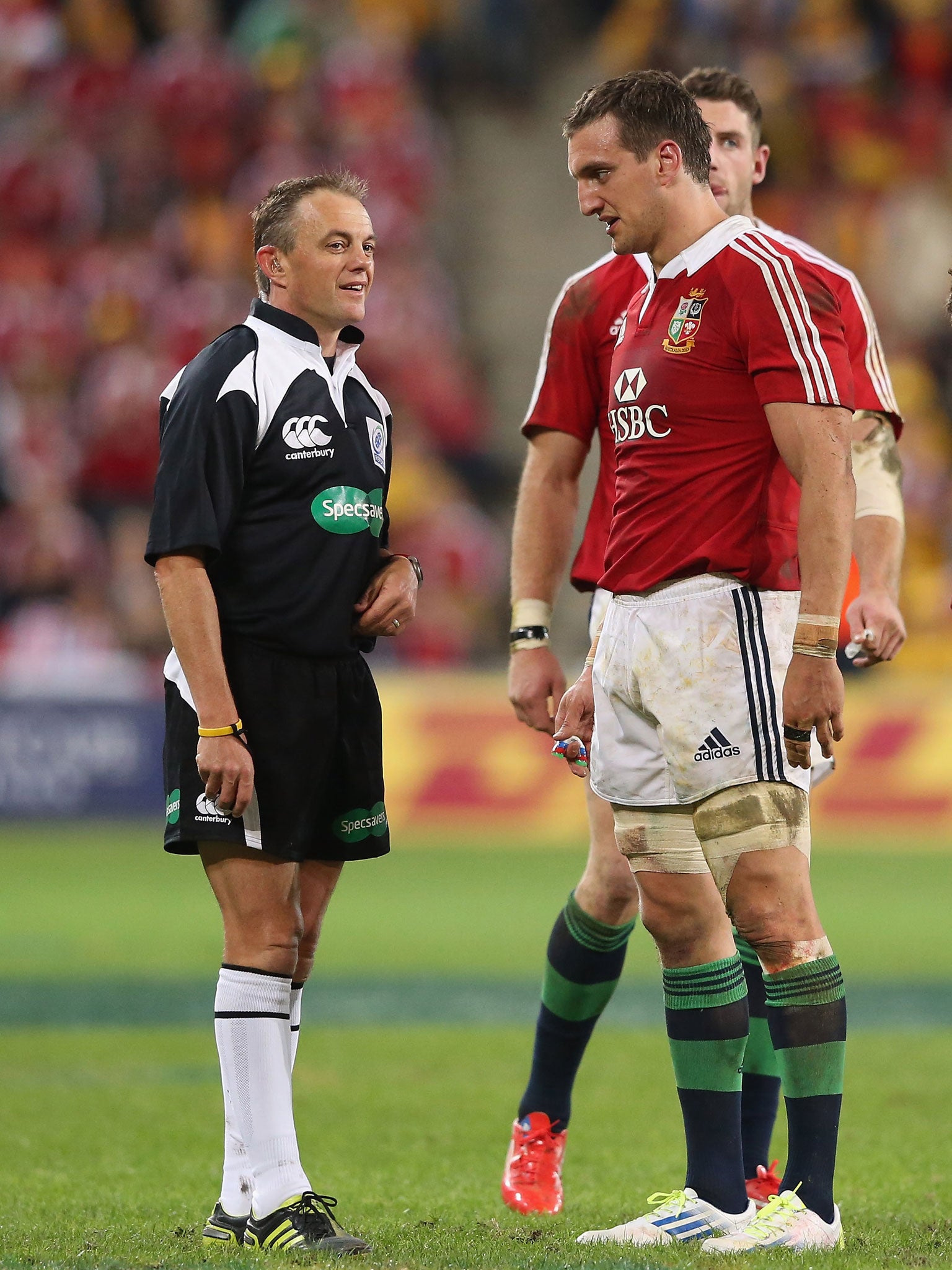 New Zealand referee Chris Pollock, left, tries to explain a decision to Sam Warburton, right