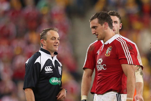 New Zealand referee Chris Pollock, left, tries to explain a decision to Sam Warburton, right