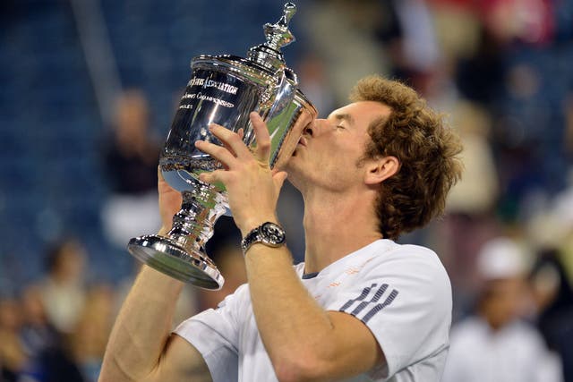Andy Murray of Britain kisses the trophy after his win over Novak Djokovic