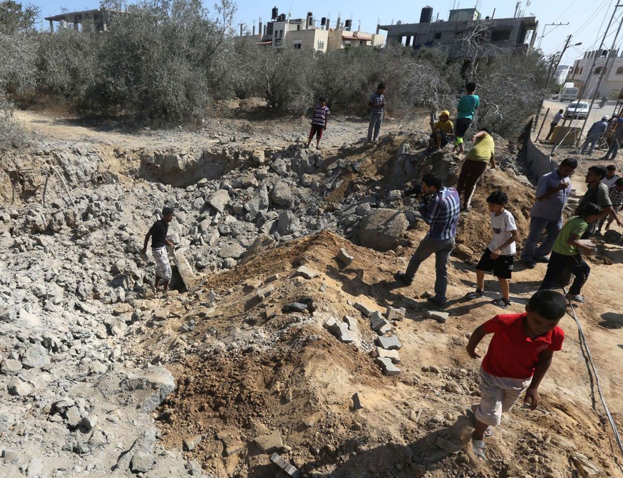 Gazans inspect the damage after the Israeli airstrike, which caused no reported fatalities