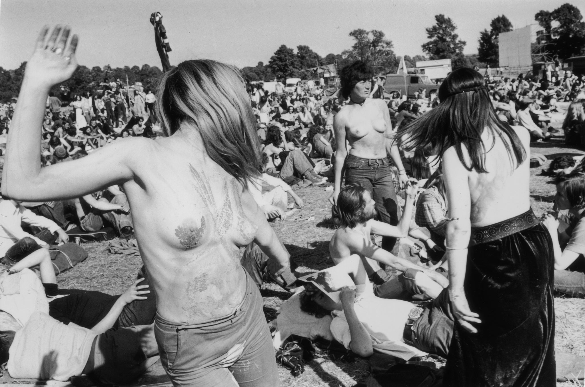 Topless hippies enjoying the sunshine at the second Glastonbury fayre, organised by Arabella Churchill and Andrew Kerr at Worthy Farm, Pilton, Somerset, 1971