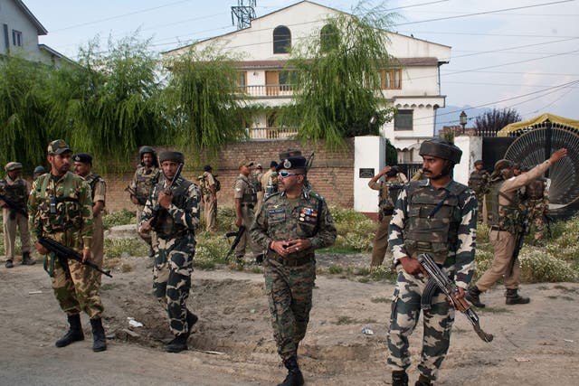 Indian policemen and paramilitary forces search for militants in residential houses after a militant attack on Indian army