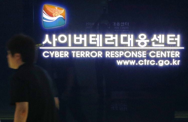 A South Korean man walks past a gate at the Cyber Terror Response Center of the National Police Agency in Seoul on 25 June 25, 2013 - the 63rd anniversary of the start of the Korean War