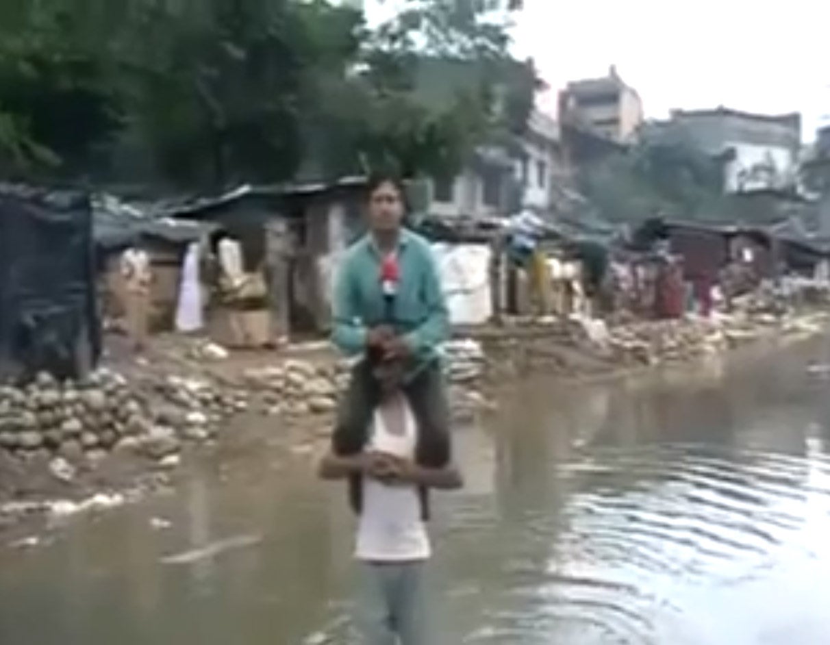 Indian TV reporter Narayan Pargaien has faced criticism for sitting on a flood victim during a news item in order not to get wet.