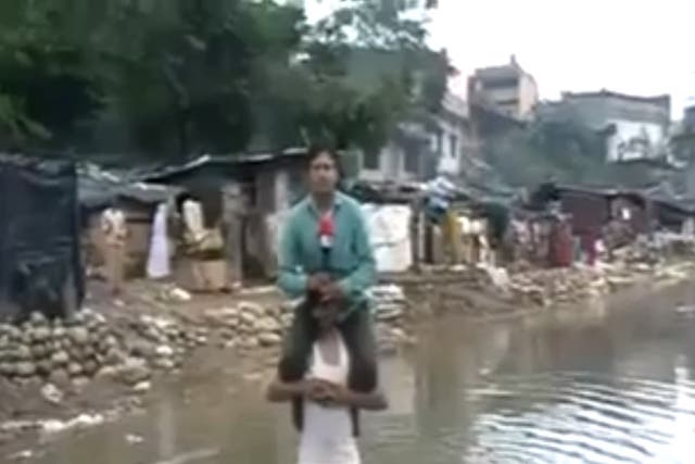 Indian TV reporter Narayan Pargaien has faced criticism for sitting on a flood victim during a news item in order not to get wet.