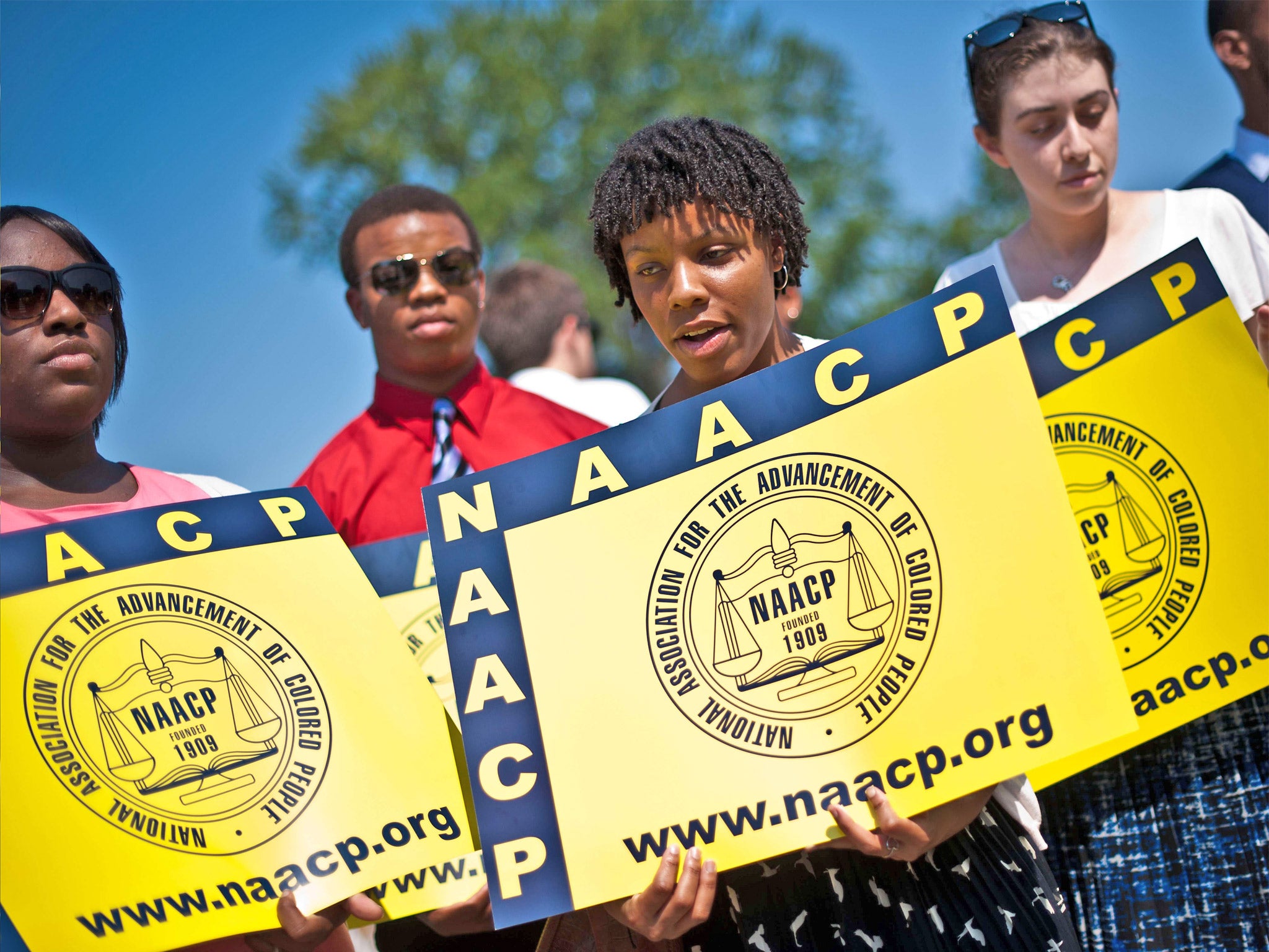 Members of the National Association for the Advancement of Colored People (NAACP) hold signs in front of the US Supreme Court