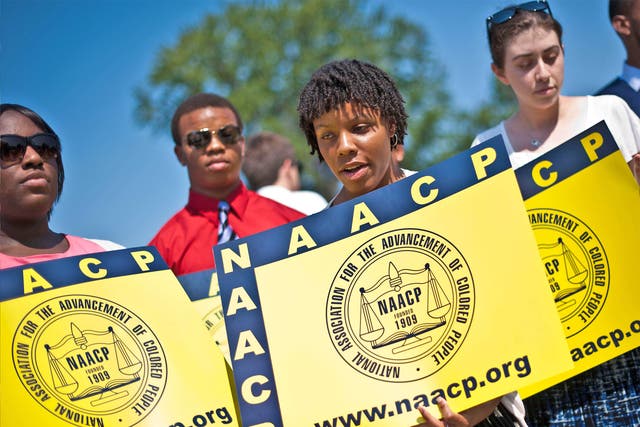 Members of the National Association for the Advancement of Colored People (NAACP) hold signs in front of the US Supreme Court