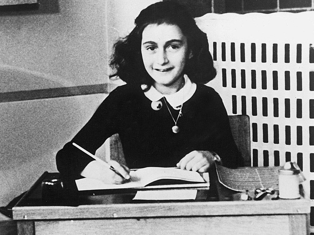 Anne Frank writing in her diary
