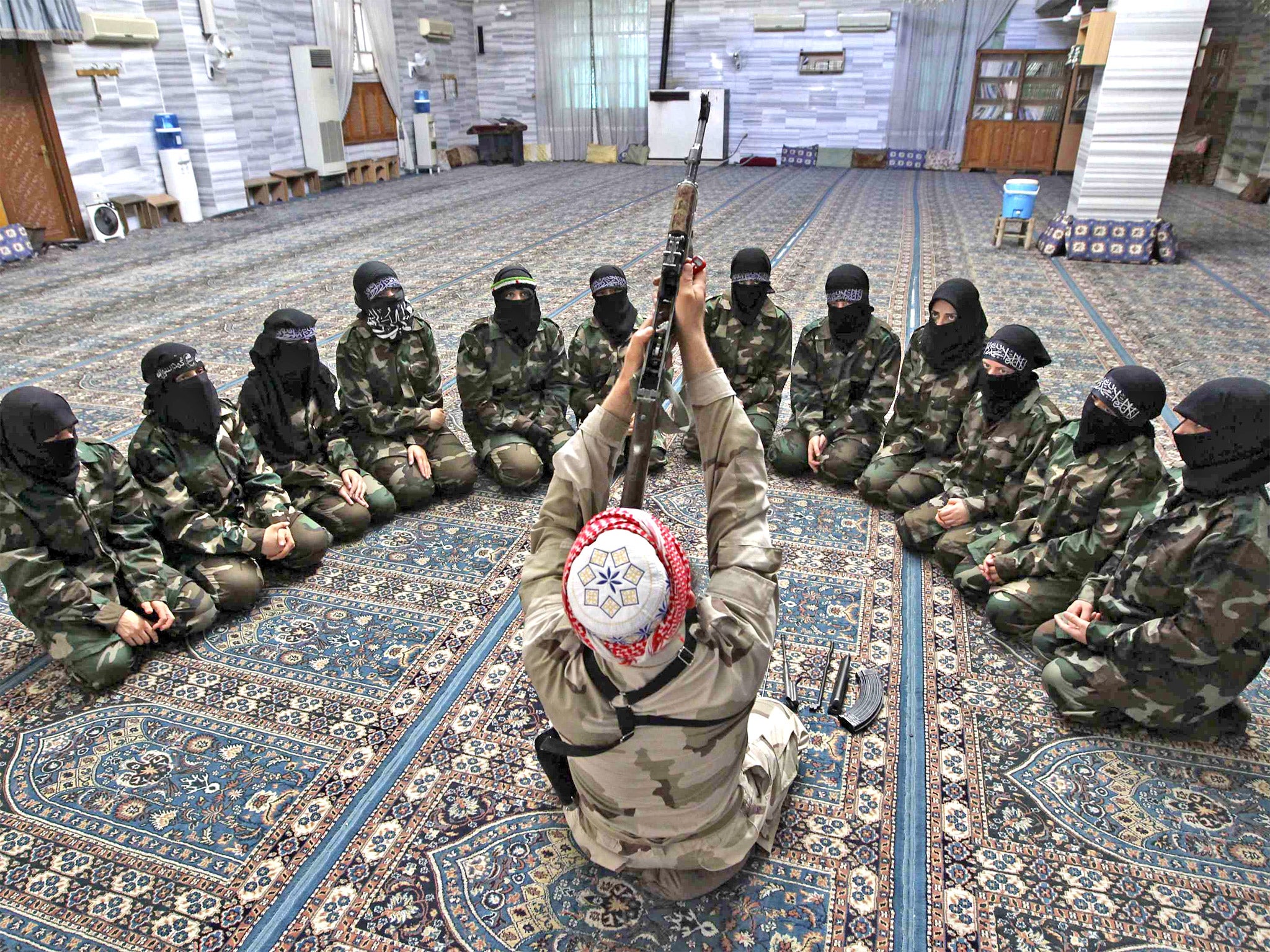 Abu al-Taib, leader of the Ahbab Al-Mustafa Battalion, addresses female recruits in Aleppo