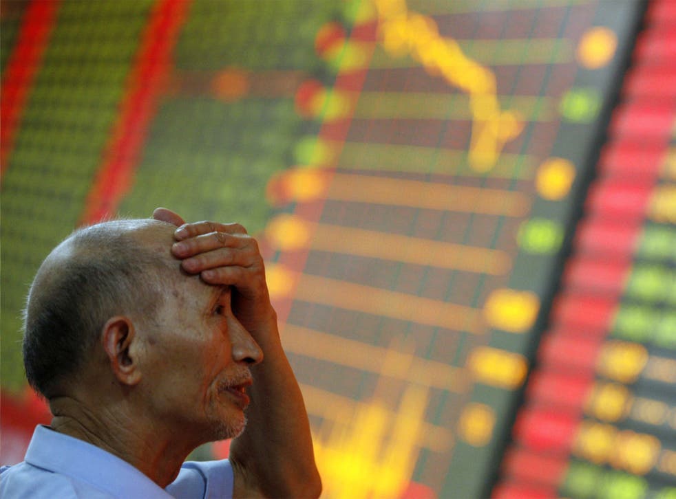 An investor gestures at the volatility of Chinese stock markets