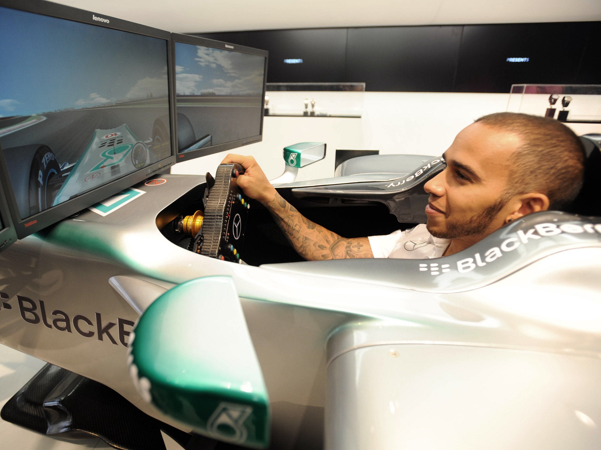 Lewis Hamilton tries out an F1 simulator in London on Tuesday